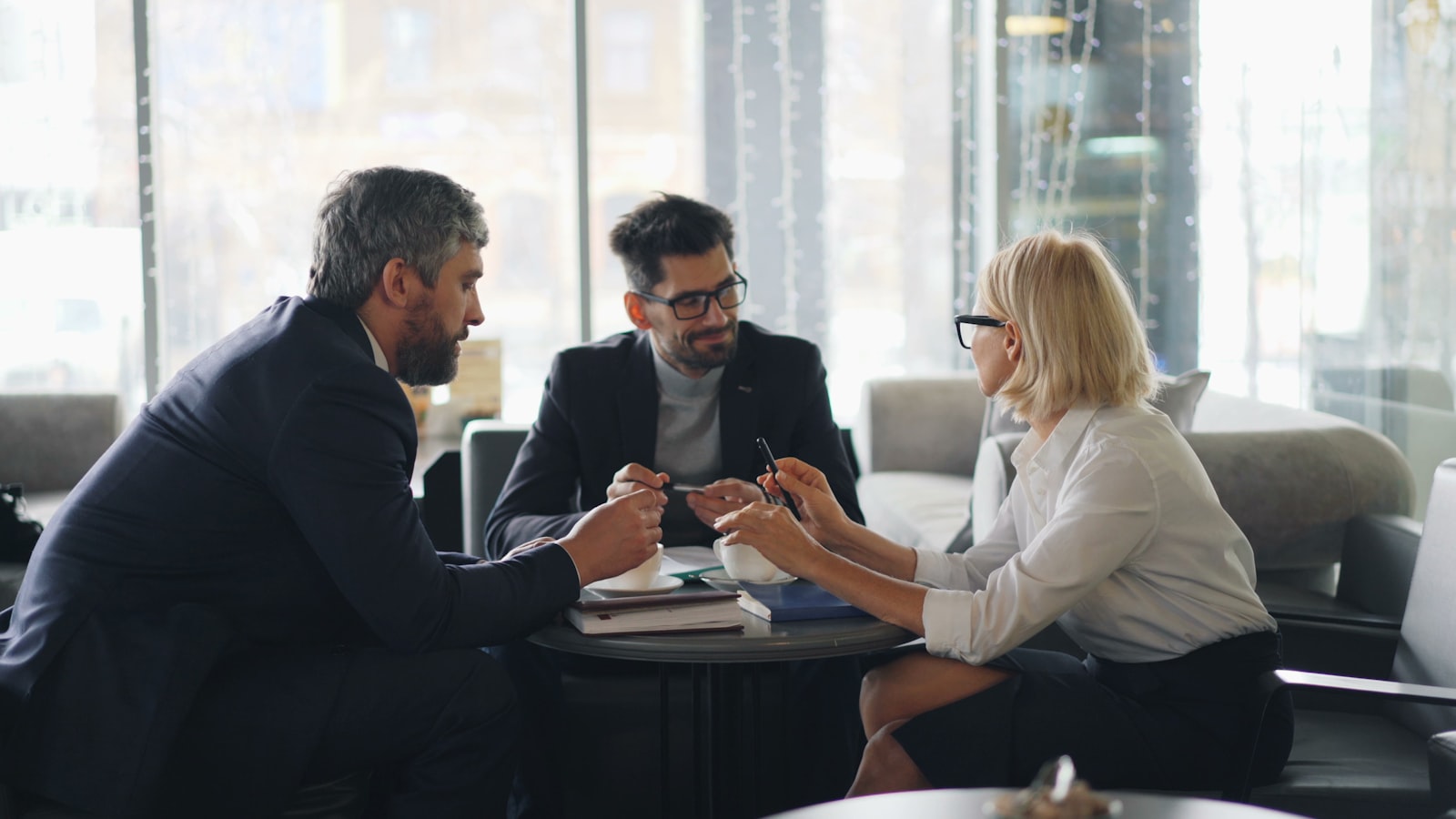 A relocation coordinator reviewing a plan with clients at a table