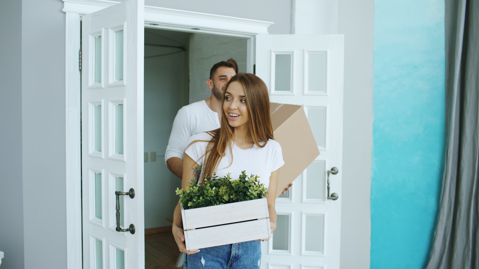 Parents and children unpacking boxes in a bright new apartment